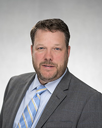 headshot of Adam Walsh - Senior Vice President and General Counsel