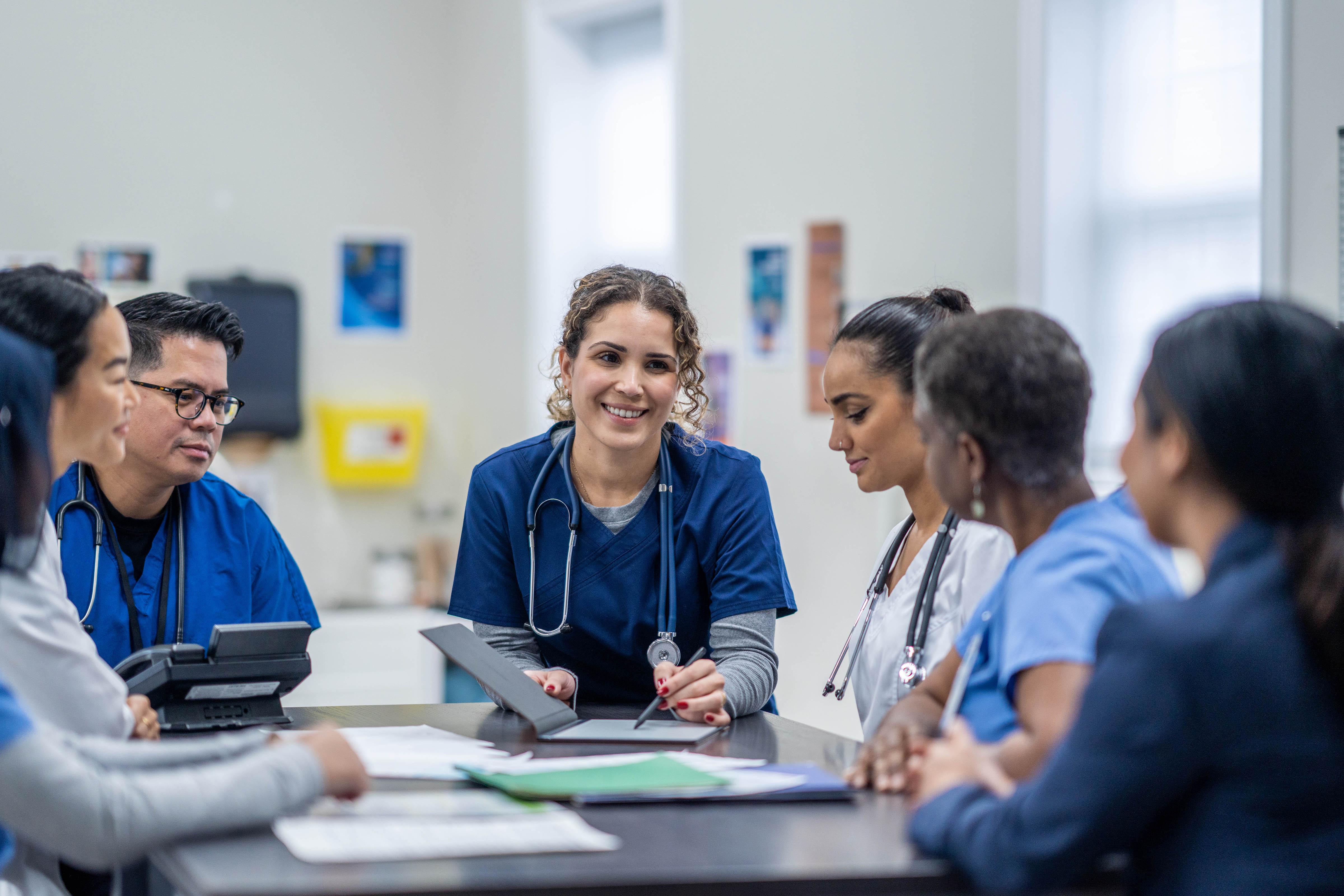 Healthcare professionals collaborating during a team meeting